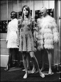 three mannequins are standing in front of each other with feathers on them