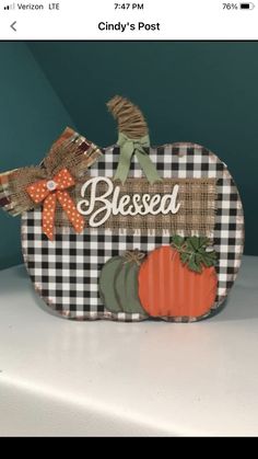 a small pumpkin sitting on top of a white counter next to a green wall with the words, blessed