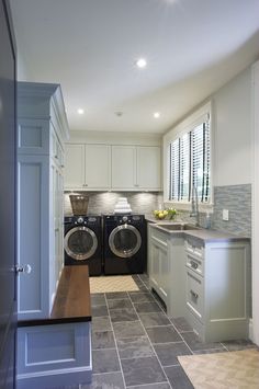 a laundry room with two washers in it