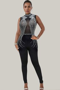 Experience exquisite luxury with the Mara Studded Mesh Sleeveless Jumpsuit. Featuring contrasting mesh and dazzling rhinestone details, the sheer sleeves add a touch of sophistication. This long, sleeveless jumpsuit boasts a regular fit and high waistline, made from a slight stretch polyester material. Be enchantingly elegant in this semi-sheer masterpiece. 88% Polyester, 12% Elastane Model is wearing size small Please allow 3-5 business days to process and ship. in cm : Size US Length Inseam Bu Chic Sleeveless Sequined Jumpsuit, Glamorous Black Sleeveless Jumpsuits And Rompers, Elegant Sleeveless Bodysuit For Evening, Elegant Sleeveless Evening Bodysuit, Sleeveless Black Glamorous Bodysuit, Glamorous Black Sleeveless Bodysuit, Elegant Sleeveless Bodysuit For Party, Elegant Embellished Sleeveless Jumpsuits And Rompers, Glamorous Embellished Bodysuit For Evening