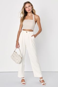 Out on the town or clocking in at the office, the Lulus Sophisticated Take Ivory High-Waisted Trouser Pants have you covered! Lightweight, crepe woven fabric shapes these chic pants that have a high-waisted fit with belt loops, a marbled top button, and a hidden zipper fly. The flowy legs have tailored pleating, side seam pockets, and ankle-length hems. Decorative welt pockets at back. Elastic at back of waist for fit. Fit: This garment fits true to size. Length: Ankle length. Size medium Inseam High Waisted Trouser Pants, Lulu Pants, Chic Pants, Lulu Fashion, Fun Pants, Pants With Pockets, Jumpsuit Trousers, High Waisted Trousers, Bottom Clothes