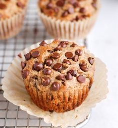 three muffins sitting on top of a cooling rack