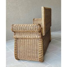 a wicker chair sitting on top of a tiled floor