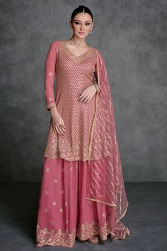 This Rose Pink Embroidered Georgette Sharara Suit showcases impeccable artistry. The anarkali top is embellished with intricate sequins, beads, and resham zari work embroidery. It comes with a heavily adorned georgette sharara bottom, featuring a four-sided lace border and a delicate net dupatta with sequins. Final Sale Fabric: Georgette Work: Embroidered Top Length: 36" Bottom Length: 40" Long sleeves 20" Elastic waist band Shape: Anarkali Lining on top & bottom Occasion: Party Wear, Wedding We Embroidery Kameez, Designer Sharara Suits, Anarkali Tops, Sharara Suits, Pakistani Style, Zari Embroidery, Sharara Suit, Kurta Dress, Party Wear Lehenga