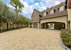 a driveway with a basketball hoop in the middle