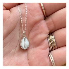 This beautiful necklace features an ethically sourced native cowrie shell in a custom made solid recycled silver setting with a silver chain.  Every necklace is handmade to order with the silver setting made custom for each shell, making each one unique.   There are two types of cowrie shell native to Cornwall, the European Cowrie ( Trivia monarcha ) and the Northern Cowrie ( Trivia arctica ).  The European cowrie is easily distinguishable from the Northern by the 3 dark spots on its shell and the fact it can grow to a larger size.  I find many cowries whilst beach-combing in Cornwall and they are one of the small number of shells I use in my jewellery. With my background in marine conservation I am acutely aware of the damage international trade in animal parts and shells inflicts on wild White Shell Necklace As Gift, White Shell-shaped Necklace For Gift, White Shell-shaped Necklace For A Gift, Sterling Silver Shell As Gift, Adjustable Fair Trade Jewelry For Gifts, Adjustable Sterling Silver Shell-shaped Jewelry, Adjustable Shell-shaped Sterling Silver Jewelry, Nickel-free Shell Gift, Handmade Silver Shell For Beach