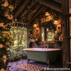 an old fashioned bathtub is surrounded by flowers and greenery in this rustic bathroom