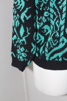 DESCRIPTION*Vintage Teal, Silver, and Black Knitted Sweater* Snowflake and Scroll Design with a Mock Neck *Ribbed Waistband and Sleeves* This Lurex Gem would be perfect with Leather Leggings.* Definitely could be worn more oversizedDETAILS*Label: Le Rouge*Size: Medium,See Measurements Below*Color: Black, Teal,  and Silver *Material: 90% Acrylic and 10% Lurex*Care: Machine wash warm; Dry Flat.*Condition: Great quality vintage/used.MEASUREMENTSBust: 40"Shoulders: 21"Sleeve: 18"Length: 24"Collar: 2 Vintage Black Fitted Sweater, Vintage Winter Knitted Patterns, Vintage Knitted Patterns For Winter, Vintage Fair Isle Patterned Sweater, Vintage Jacquard Knit Sweater, Black Vintage Sweater With Fair Isle Pattern, Vintage Patterned Crew Neck Sweater, Vintage Stretch Sweater For Winter, Legging Cuir