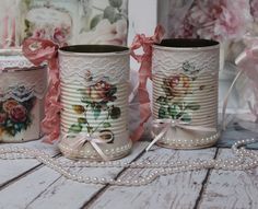 three tin canisters decorated with roses and pearls