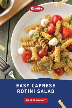 a white plate topped with pasta and tomatoes