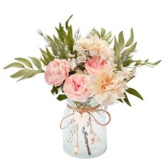 a vase filled with pink flowers and greenery