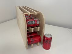 a wooden holder holds six cans of soda