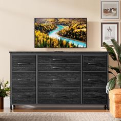 a living room scene with focus on the chest of drawers and artwork hanging above it