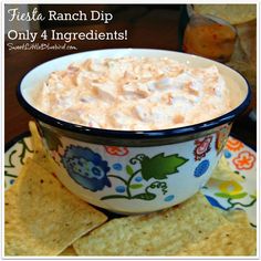 a bowl of dip with tortilla chips on the side