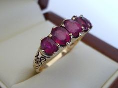 BEAUTIFUL Victorian Inspired 9CT/9K SOLID GOLD RUBY VINTAGE SCROLL RING This lovely Vintage Inspired ring has been crafted from 9ct Solid Gold. Five Natural Ruby gemstones bring this ring to life. All gemstones are oval cut and prong set. A marvellous feature is that on the shoulders of this lovely Victorian designed ring is a scroll pattern which makes this ring more appealing to the onlooker and wearer alike. THIS VICTORIAN INSPIRED RUBY RING IS TRULY AN EXQUISITE FINE JEWELLERY PIECE WHICH IS Vintage Ruby Ring Victorian, Vintage Ruby Ring, Garnet Ring Gold, Scroll Ring, Ruby Ring Vintage, Vintage Inspired Rings, Rings Collection, Scroll Pattern, Garnet Ring