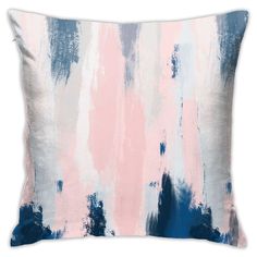 a pink, blue and white pillow on a white background with an ombreed design