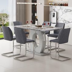 a dining room table with four chairs and a wine bottle on the top shelf in front of it