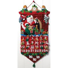 a christmas banner hanging on the wall with santa claus and other holiday decorations around it