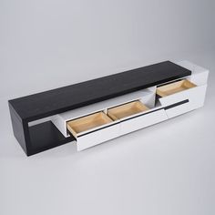 a white and black table with drawers on it