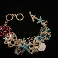 Gorgeous Bracelet With Shells , Starfish And Sea Colored Crystals Toggle Clasp Goldtone Nwt Measures 7 1/2 Inches To 81/2 Inches. D149 Beach Jewelry With Lobster Clasp, Beach Metal Jewelry With Starfish Charm, Metal Starfish Jewelry, Beach Charm Bracelet With Lobster Clasp, Bracelet With Shells, Beach Themed Bracelet, Sea Colour, Beach Themed, Gorgeous Bracelet