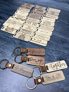 wooden keychains with names and date tags on them sitting on a table next to each other