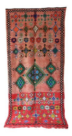 an old rug with many different colors and designs on the front, one is red