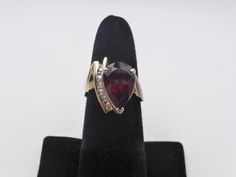 Indulge in timeless elegance with this SUPER Red Tourmaline Teardrop Ladies 10K Solid Gold Vintage Ring. This exquisite piece combines the allure of a vibrant red tourmaline teardrop with the sparkle of small, beautifully set diamonds, all in a classic yet modern design. Material: 10K Solid Gold (marked) Gemstone: Teardrop Red Tourmaline Accent Stones: Series of small diamonds Weight: 5.9 grams (3.7 dwt) Size: 7 Condition: Excellent condition, ready to dazzle! This ring's design offers a stunning blend of vintage charm and contemporary style. The teardrop-shaped red tourmaline is a striking focal point, while the series of small diamonds adds a touch of brilliance. Whether you're adding to your jewelry collection or searching for the perfect gift, this ring is sure to impress. Why You'll L Formal Red Pear-shaped Ruby Ring, Formal Pear-shaped Ruby Ring, Red Pear-shaped Ruby Ring, Formal Teardrop Ruby Ring In Fine Jewelry Style, Formal Teardrop Ruby Ring Fine Jewelry, Teardrop Ruby Ring For Formal Occasions, Formal Teardrop Ruby Ring, Classic Teardrop Ruby Ring For Formal Occasions, Red Pear-shaped Ring For Formal Occasions