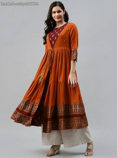 HAND MADE KURTA WITH JACKET * Colour: orange and Maroon * Ethnic motifs printed * Round neck * sleeveless kurta * Anarkali shape * Ankle length with flared hem * Comes with a longline ethnic jacket, has three quarter sleeves, tie-up closure, tiered styling * Machine weave regular viscose rayon *Fabric:- Viscose rayon *Wash Care:- Dry clean AVAILABLE IN 5 SIZES THEY ARE IN FOLLOWING MEASUREMENTS IN INCHES:- S:- Bust-36/Waist-32/Shoulder-14.5/Hips-38/Sleeves Length-17/Top Length-52 M:- Bust-38/Wai Anarkali Kurta For Fall Festive Occasions, Festive Fall Anarkali Kurta, Navratri Orange Anarkali Set With Printed Motifs, Festive Orange Anarkali Set With Printed Motifs, Long Bohemian Dresses For Diwali, Bohemian Orange Dress With Printed Motifs, Bohemian Dresses With Bandhani Print, Semi-stitched, Festive Printed Kurta For Fall, Orange Anarkali Dress With Printed Motifs