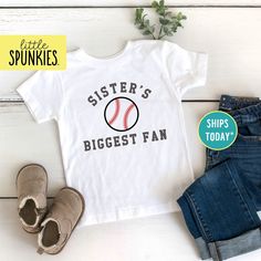 Baseball Season Shirts for Kids, Sisters Biggest Fan Toddler T-Shirt, Game Day Shirts PRODUCTION TIME Little Spunkies from the designer/owner of Spunky Pineapple Co https://www.etsy.com/shop/SpunkyPineappleCo   All baby and toddler clothes are 100% designed and printed with water based ink. All orders placed before 12:00 pm EST are shipped out same day (Monday - Friday). Orders received after noon are shipped out the next business day. ONESIES® BRAND  Made from 100% Cotton. We print on Onesies® Brand and do recommend ordering up one size as these run a little small after washing. T-SHIRT Made from 100% Cotton. These run true to size. If you are in between sizes we suggest sizing up. RAGLAN Made from 52% Cotton / 48% Polyester. These run true to size. If you are in between sizes we suggest Cotton Baseball Jersey For Fan Gear With Team Spirit, Cotton Baseball Jersey For Fan Gear, Sports Season Fan Gear Baseball Jersey With Letter Print, Crew Neck Baseball Jersey With Name Print For Fans, Varsity Cotton T-shirt For Baseball Season, Cotton Baseball Jersey For Fans, Cotton Baseball Jersey With Short Sleeves For Fans, Cotton Short Sleeve Baseball Jersey For Fans, Team Spirit Cotton Baseball Jersey For Baseball Season