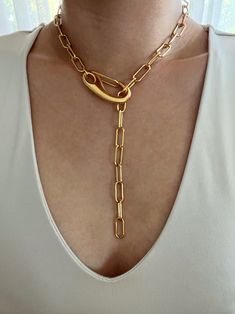 Chunky gold paperclip lariat featuring a large clasp. Necklace can clasp anywhere on the chain for different looks. Necklace is gold plated stainless steel. It is of great importance to me that I make jewelry for my customers that I, myself, wear every day. Each jewelry piece is handmade by me personally with love and care. Each item is crafted to the highest quality and made to exceed the expectations of my customers. My jewelry is designed to you to love and wear no matter what the occasion at Elegant Lariat Chain Necklace With Lobster Clasp, Elegant Lariat Chain Necklace With Toggle Clasp, Everyday Gold Lariat Necklace With Lobster Clasp, Formal Lariat Jewelry With Paperclip Chain, Formal Lariat Toggle Necklace With Chain, Formal Lariat Toggle Necklace, Metal Lariat Necklace With Chain, Metal Lariat Necklace With Chunky Chain, Metal Lariat Necklace With Chain Detail