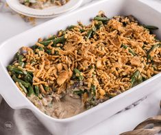 a casserole dish filled with green beans and mushrooms