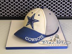 a cake with a hat on top of it that says cowboy's blue note bakery