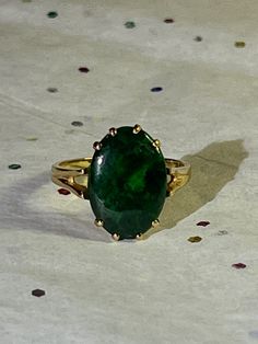 Behold the timeless elegance of this exquisite 14k emerald cabochon ring. Crafted with precision and passion, this ring features a captivating  emerald, exuding a mesmerizing green hue that dances in the light. Set upon a beautiful 14k gold band, adorned with delicate details, this piece embodies sophistication and grace. Whether worn as a statement piece or cherished as a symbol of love and commitment, this ring is sure to leave a lasting impression. Emerald Cabochon, Estate Ring, Estate Rings, Cabochon Ring, Delicate Details, Love Symbols, Gold Band, Rings Statement, Gold Bands