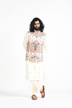 Ivory floral hand embroidered nehru jacket with intricate details on Linen Satin. Paired with Ivory slim fit Pant Pajama. Color of the actual garment may vary due to lighting conditions during the shoot.

Size Chart For Men





	
	
					Men's Size Chart
		

		
		
						
				Size Chart For Men
				Custom Size Measurement Guide
			
			
				
				
				Custom Size Measurement Guide
1. Take your measurements at ease…don’t hold your breath!
2. Be a little generous with the measurements. It’s always ea White Churidar With Floral Embroidery For Transitional Season, Cream Bandhgala With Chikankari Embroidery For Transitional Season, Traditional Cream Lawn Suit With Dabka, Unstitched Off-white Bandhgala For Eid, Unstitched Off White Bandhgala For Eid, Designer Cream Embroidered Bandhgala, Designer Off-white Bandhgala With Intricate Embroidery, Off White Bandhgala With Intricate Embroidery For Designer Wear, Festive Off-white Lawn Suit With Intricate Embroidery