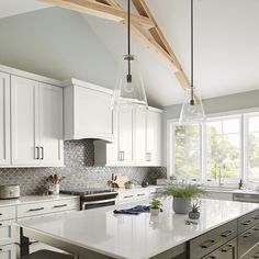 a large kitchen with white cabinets and an island in the middle is shown, along with wooden beams on the ceiling