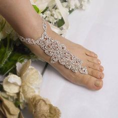 --Wedding Rose Gold ,Silver Barefoot Sandals, Bridal Foot Jewelry, Rhinestone Foot Jewelry, Footless Sandal,Bridesmaid Foot Jewelry -SD 039-- This stunning silver rhinestone footless sandal is the perfect accessory for a beach or garden wedding. This sandal is made from an clear rhinestone covered rose gold plated applique and satin or grosgrain ribbon. It is very comfortable and adjustable. We have the silver color rhinestone too. **This listing is for 1 PAIR (2 pcs) of barefoot sandals. **Mode Silver Sparkling Open Toe Wedding Shoes, Silver Open Toe Wedding Shoes For Bridal Shower, Elegant Silver Barefoot Sandals With Rhinestones, Silver Rhinestone Wedding Shoes For Bridal Shower, Silver Toe Ring Barefoot Sandals With Rhinestones, Silver Bling Wedding Shoes, Gold Barefoot Sandals, Bridal Foot Jewelry, Wedding Rose Gold