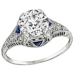 an antique style diamond and sapphire engagement ring