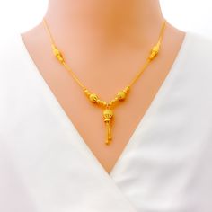 This dressy 22k gold necklace features a stunning beaded design, adding a touch of elegance and sophistication to any outfit. Weighing 9.6 grams, it offers a luxurious yet comfortable feel. The radiant yellow gold finish enhances its opulent appeal. With a necklace length of 18.5 inches and a drop length of 1 inch, this piece is perfect for making a stylish statement. The secure lobster lock ensures confident and comfortable wear. Elevate your jewelry collection with this exquisitely crafted beaded necklace, ideal for bringing a touch of dressy elegance to both everyday and special occasions. PRODUCT DETAILS Gold Purity(karat): 22k Gold Weight(grams): 9.6 Item Finish: Yellow Gold Necklace Length: 18.5" Drop Length: 1" Lock Style: Lobster Lock Elegant Festive Necklaces With Gold Beads, Elegant Gold Beaded Necklaces For Festive Occasions, Elegant Festive Gold Beaded Necklaces, Yellow Gold Necklaces With Polished Beads For Weddings, Elegant Yellow Gold Chain Necklace For Festive Occasions, Elegant Temple Necklace With Gold Beads For Festive Occasions, Elegant Gold Plated Yellow Bridal Necklace, Festive Formal Necklace With Gold Beads, Festive Formal Necklaces With Gold Beads