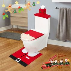 a bathroom decorated for christmas with santa's hat on the toilet and other decorations