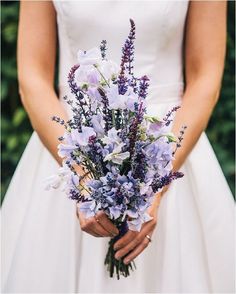 a bride holding a bouquet of flowers in her hands