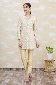 Beige dupion silk panelled achkan jacket style  kurta with floral thread work embroidery all-over. Paired with beige trouser.
Components:2
Embroidered
Neckline:V-Neck
Sleeve Length:Full
Fabric:Dupion Silk
Color:Beige
Front closure kurta
Side slit kurta - Aza Fashions Beige Trouser, V Neck Kurta, Pant For Women, Dupion Silk, Luxury Sale, Embroidered Neckline, Kurta With Pants, Silk Embroidery, Thread Work