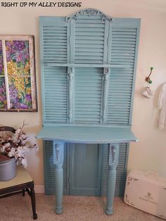 a blue cabinet sitting next to a chair in a room