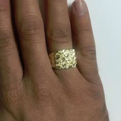 a woman's hand with a gold ring on it