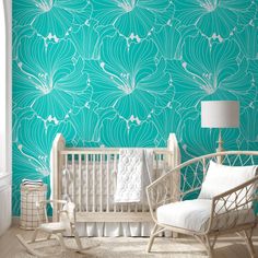 a baby's room with a crib, rocking chair and large wallpaper