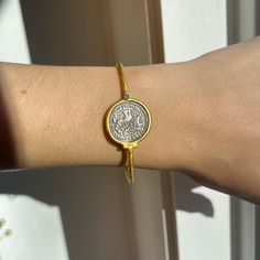 24KT yellow gold-plated + sterling silver replica Roman coin bangle with diamond. Double-sided silver coin set with textured, matte finish to the gold bangle! Length: 7" approx. Diameter: 60mm Band width: 2mm Weight: 11.80 grams (1) .01 CT natural, round diamond 21mm round replica coin Hook style clasp 925 sterling silver purity with 24KT gold plating Adjustable Engraved Gold Bracelet, Engraved Adjustable Gold Bracelet, Gold Tarnish-resistant Round Bangle, Luxury Silver Brass Bangle, Hammered Gold Bracelet Gift, Tarnish Resistant Gold Round Bangle, Engraved Gold-plated Round Bracelet, Engraved Round Gold-plated Bracelet, Engraved Gold-plated Bracelet