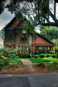 a house with trees and bushes in front of it