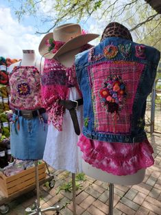 three dresses and hats are on display at the market, including one with a cowboy hat