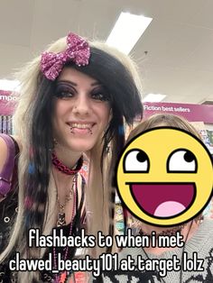 a woman with long hair and an emo make - up is smiling at the camera