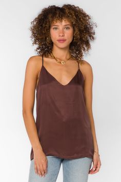 Stay sleek and chic with our Moxie Cami. Crafted with racer back, v-neck, and spaghetti straps, this satin camisole is designed to flatter any look.. Material: 100% Viscose Machine wash cold Color: Brown V-neck Spaghetti straps Model is 5'9" and wearing a size S Imported Silk V-neck Tank Top With Adjustable Straps, Silk V-neck Camisole With Adjustable Straps, Satin V-neck Camisole With Delicate Straps, Silk Cami Tank Top With Built-in Bra, V-neck Top With Adjustable Straps For Night Out, Chic V-neck Camisole With Straps, Satin Tank Top With Built-in Bra, Sleek Camisole With Built-in Bra For Night Out, Chic V-neck Tank Top With Adjustable Straps