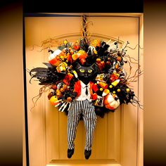 a halloween wreath hanging on the front door